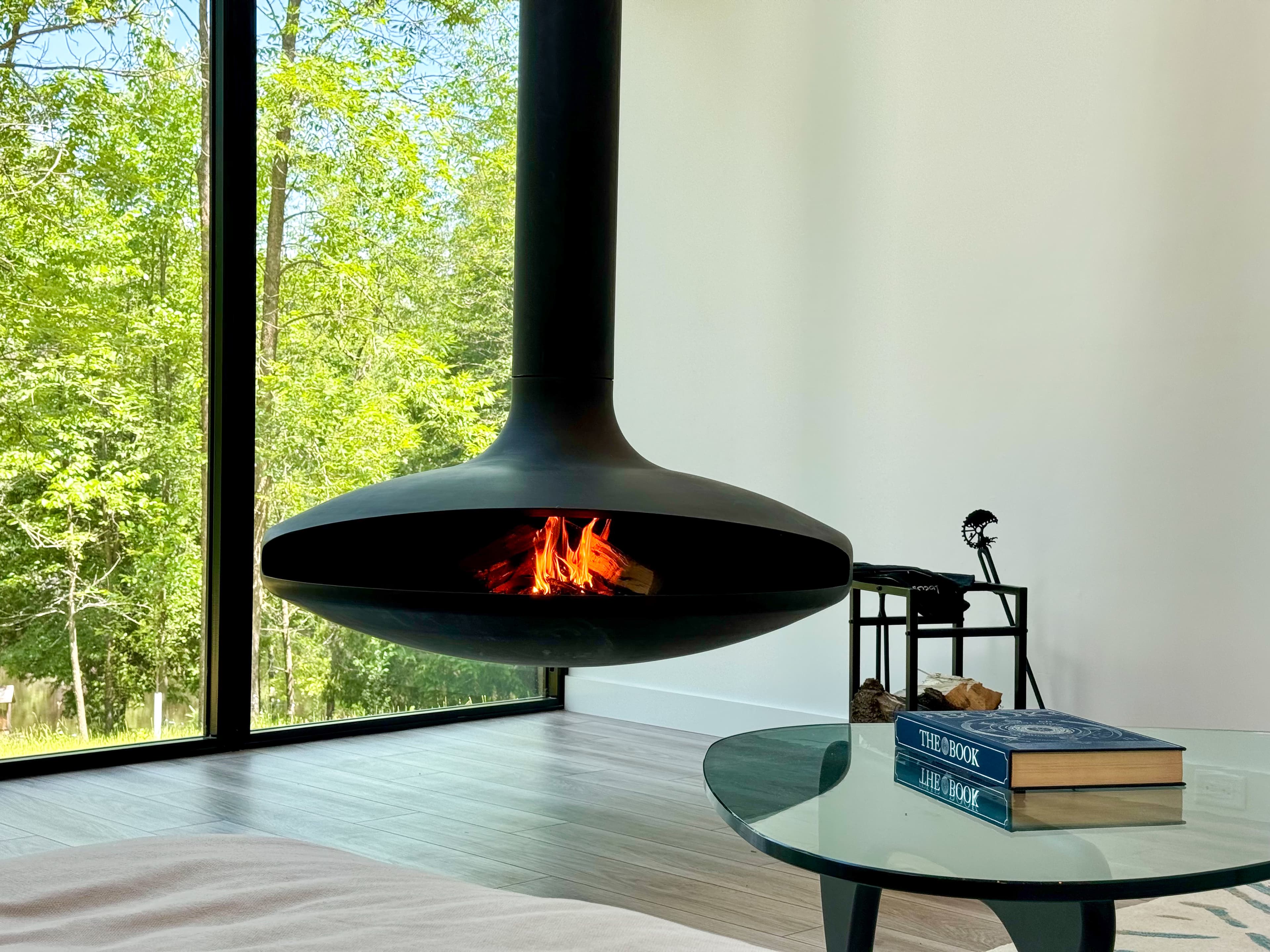 Suspended wood-burning fireplace with floor-to-ceiling windows