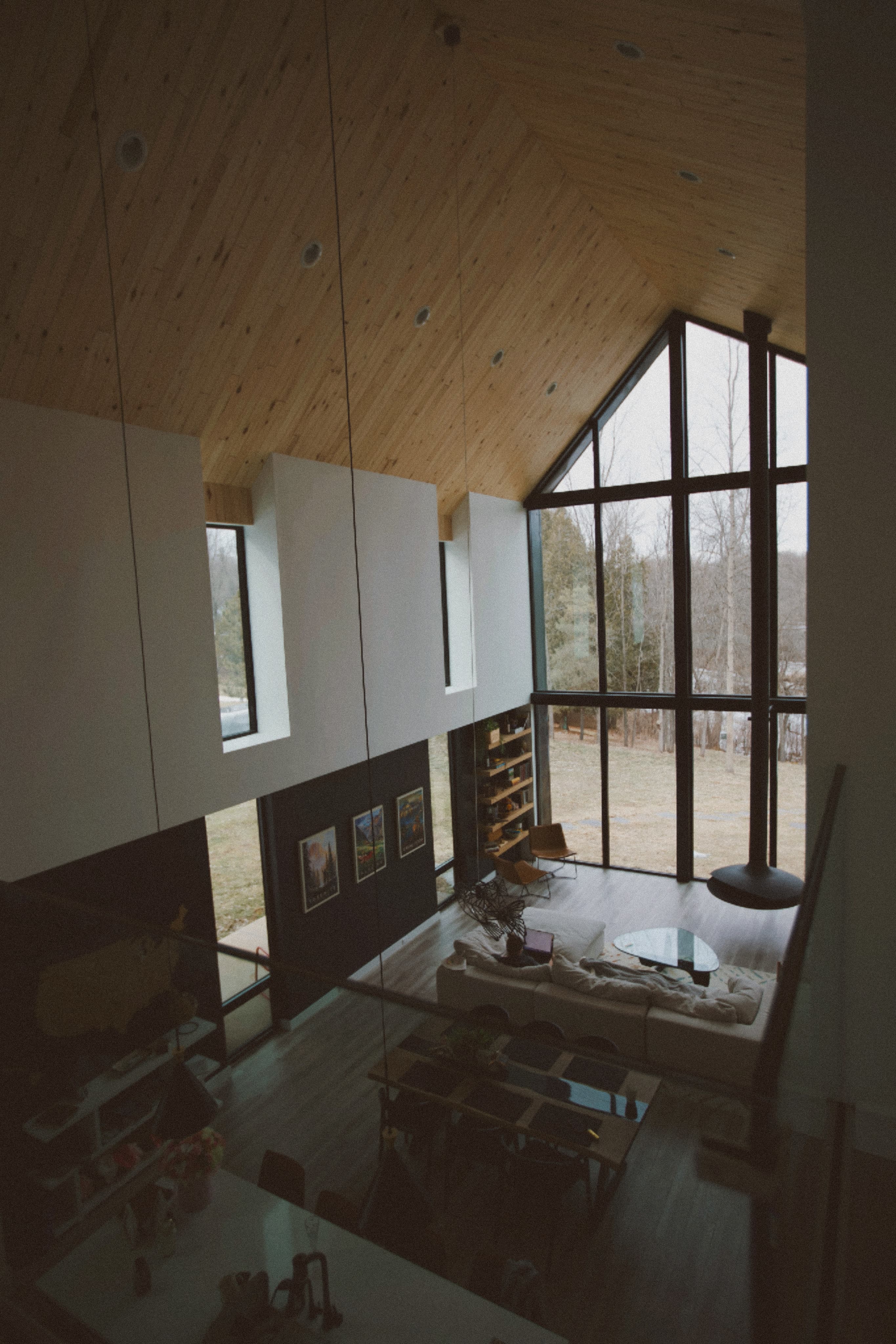 Great room — cathedral ceiling, floor-to-ceiling Pella windows, Oconto River view
